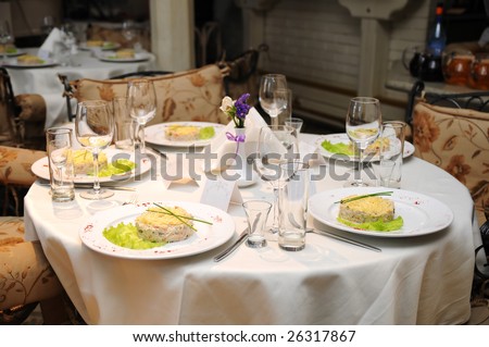 Wedding table with decoration in fine restaurant with food served in plates