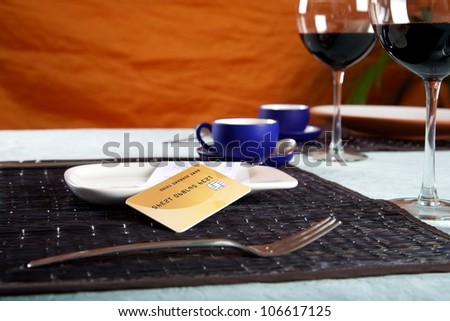 bill and credit card on white plate at restaurant