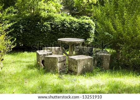 stone circular table and seven cube chairs at a park in saragossa spain