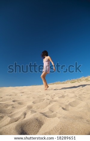 woman with violet dress at el palmar beach in cadiz spain
