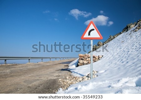 danger curve sign and snow in salamanca spain