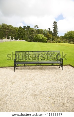 classic metal bench with crushed stones and grass