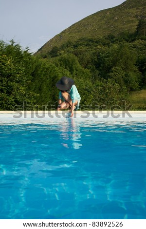 woman barefoot at swimming pool border in Asturias Spain