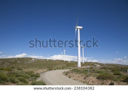 group of white wind renewable power turbines in country next to Madrid Spain Europe