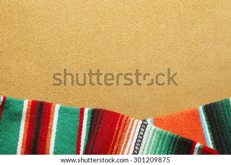 Colorful mexican blanket on warm gold background