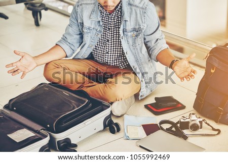 An Asian male traveler is experiencing the problem of need and lost value at the airport.