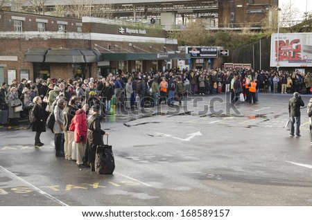 HAYWARDS HEATH, UK - DECEMBER 24th: People waiting / delayed at train station after the bad storm on December 24th, 2013. The storm caused many delays, stopping people getting home for Xmas.