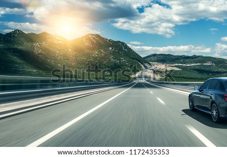 Car rushing along a high-speed highway.
