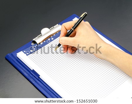 Notepad and pen in hand