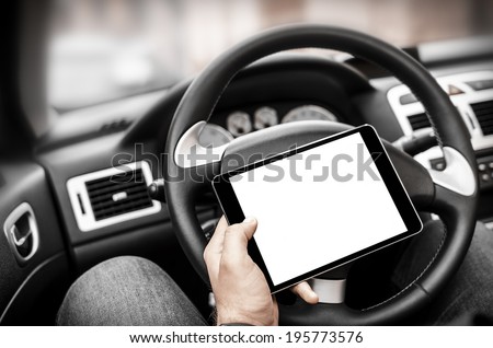 Man in the car, with the Tablet PC in hands