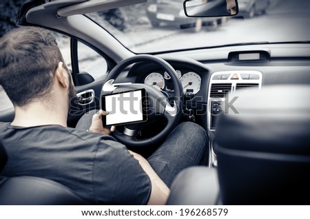 Man in the car with tablet pc
