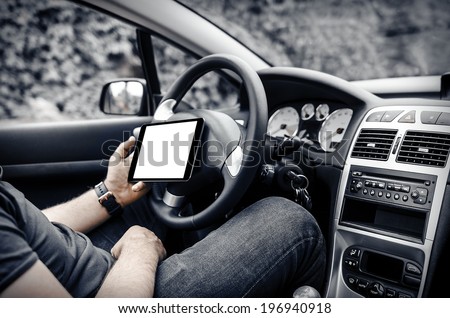 Man in the car, with the Tablet PC in hands