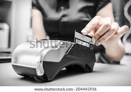 Female hand holding plastic card in payment