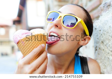 Smiling girl with ice cream in the hands of
