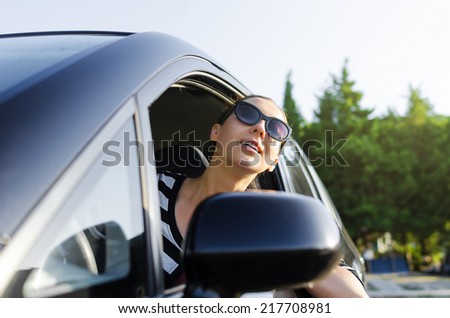 Woman drives a car on the road