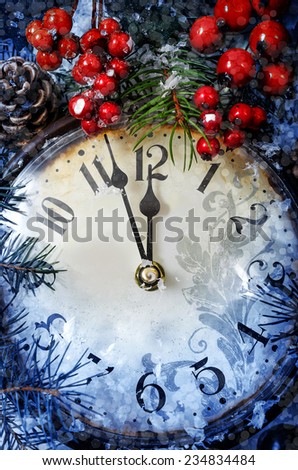 Christmas Eve and New Years at midnight. Clock covered with snow.