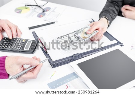 Business people exchanging dollar banknotes. Closeup shot of hands