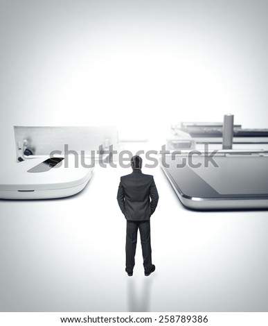 Man in a suit is surrounded by a huge computer hardware, computer city. Conceptual technology image.