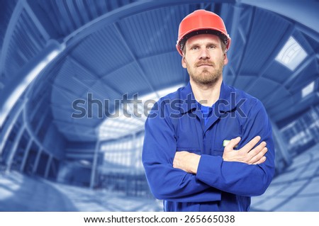 Construction worker man in helmet . Against the background of building buildings.