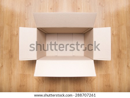 Empty brown carton box on the wooden floor