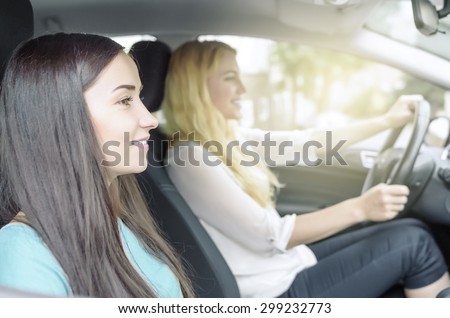 Girls in the car. Two attractive woman in car, close-up. Travel concept.