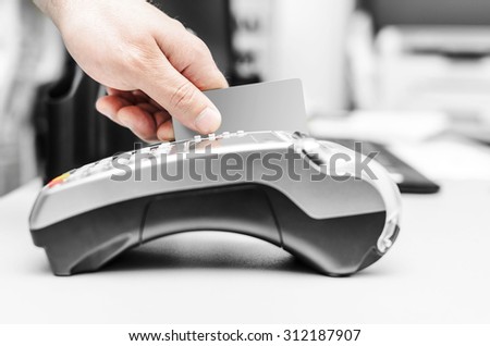 Debit card swiping on bank terminal. Business concept.