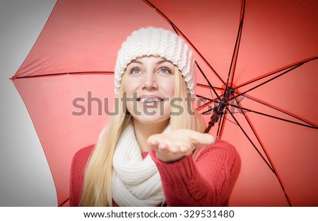 Beautiful blonde with red umbrella isolated on white.
