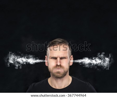 Angry man with smoke or fume coming out from his ears on dark background.