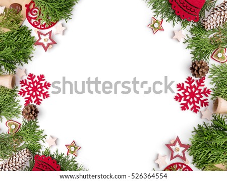 Christmas still life. Red toys, spruce branches and decorative Christmas ornaments on a white background.