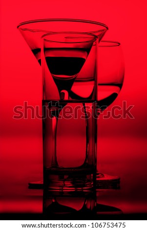 three graphic glasses of red wine of white wine on it is black ared background silhouettes in a bright wine shades of black outlines