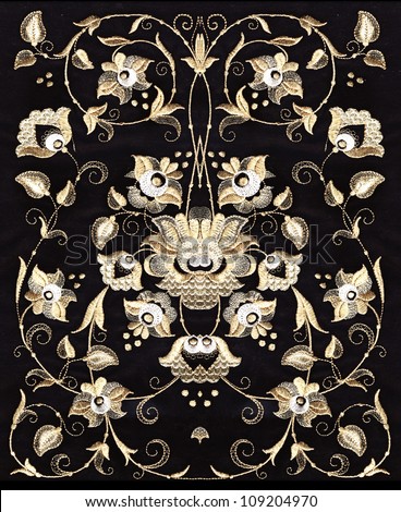 embroidery of gold and silver with white inlay on a black background
