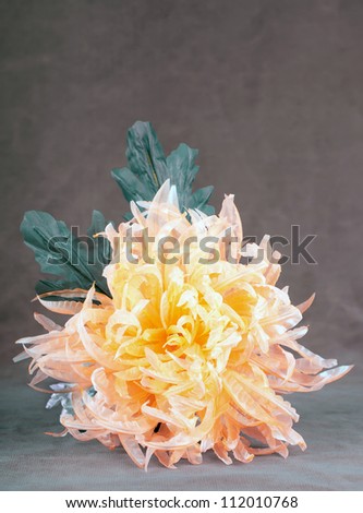 chrysanthemum of textiles organza bright orange yellow and gold shades with textile leaves green blue grey black velvet with a place for text
