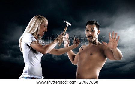 Lady with Hammer and Nail beating to a bare chest man