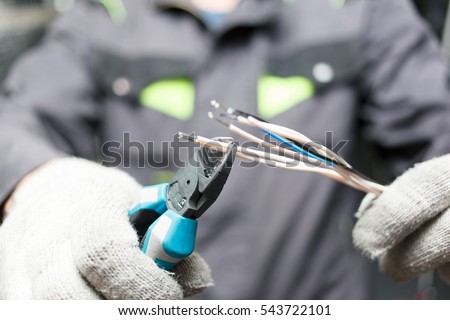 Hands of young electrician close up. Engineering profession.
