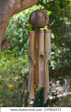 Coconut / Bamboo Wind Chimes hanging in an Olive Tree, suggesting serenity and meditation