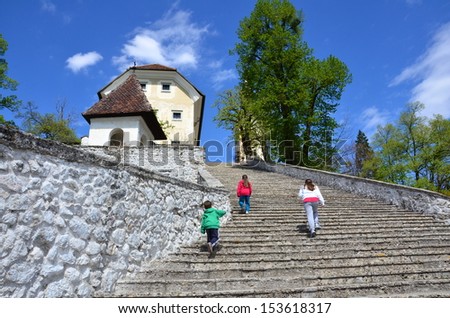 Climbing stairs - Three siblings climbing the famous 99 stairs of the Bled Church of the Assumption of Mary