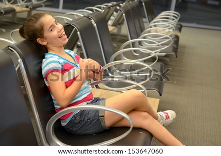 Girl at the airport - Happy teenager girl waiting for her flight at the airport
