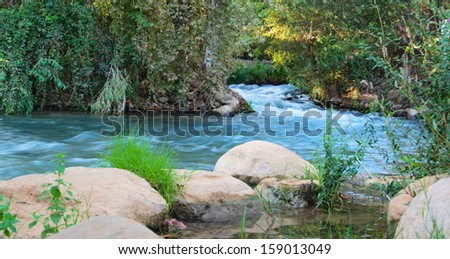 Jordan River - Summer day on the Jordan River at the Hazbani, one of the streams feeding the main Jordan in the North of Israel