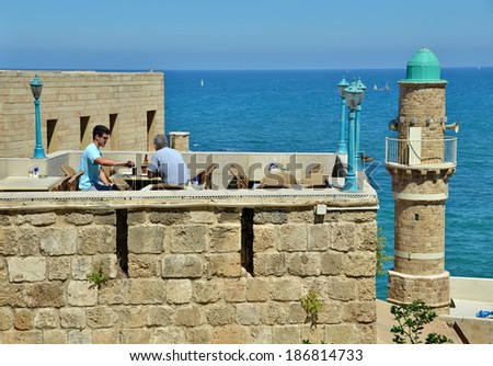 JAFFA, ISRAEL - APR 11, 2014: People eating breakfast with views of the Mediterranean in Jaffa, Tel Aviv, Israel