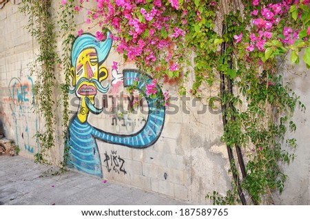 JAFFA, ISRAEL - APR 11, 2014: Graffiti in the shape of a blue-haired man on a wall in Jaffa, Tel Aviv, Israel
