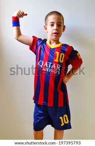 TEL AVIV, ISRAEL - JUNE 8, 2014: A boy modeling the FC Barcelona Football / Soccer blue and red striped uniform featuring #10 - Lionel Messi and Qatar Airways banner