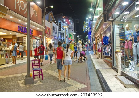 HERSONISSOS, GREECE - JULY 21, 2014: Young people touring and shopping the action-packed and trendy streets of Crete, the Greek Mediterranean Island on a warm summer night