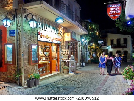 MALIA, GREECE - JULY 22, 2014: Creten Dinner Time - People eating dinner outdoors in Greek Tavernas and walking the streets at Malia Old City in Crete, Greece