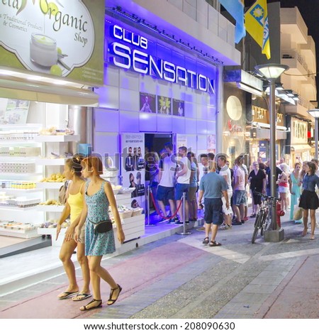 HERSONISSOS, GREECE - JULY 21, 2014: Young people touring and shopping the action-packed streets of Crete, the Greek Mediterranean Island on a warm summer night
