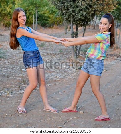 Best Friends Forever - two 12 year old teenage girls  holding hands