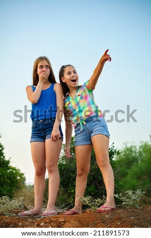 Best Friends Forever - two 12 year old teenage girls pointing in awe and surprise