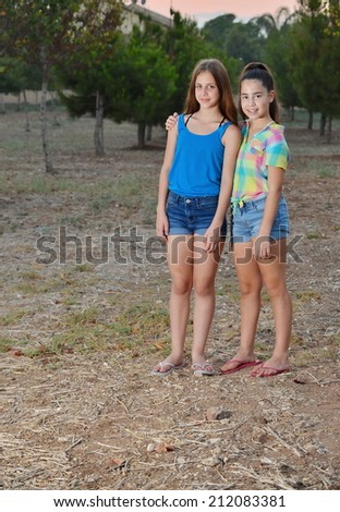Best Friends Forever - two 12 year old teenage girls  hugging at sunset