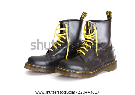 TEL AVIV, ISRAEL - SEPT 28, 2014: A pair of Doc Martens 8 eyelet 8 inch classic unisex black lace-up fashion combat boots with yellow laces and the sole visible