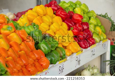 Fresh colorful produce in a Jerusalem fruit and vegetable market: orange, green, red, and yellow bell peppers