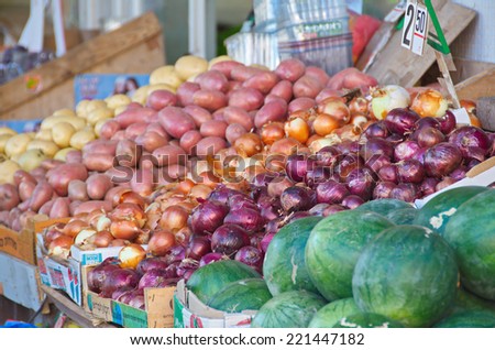 Fresh colorful produce in a Jerusalem fruit and vegetable market: assorted onion and potatoes, and watermelon
